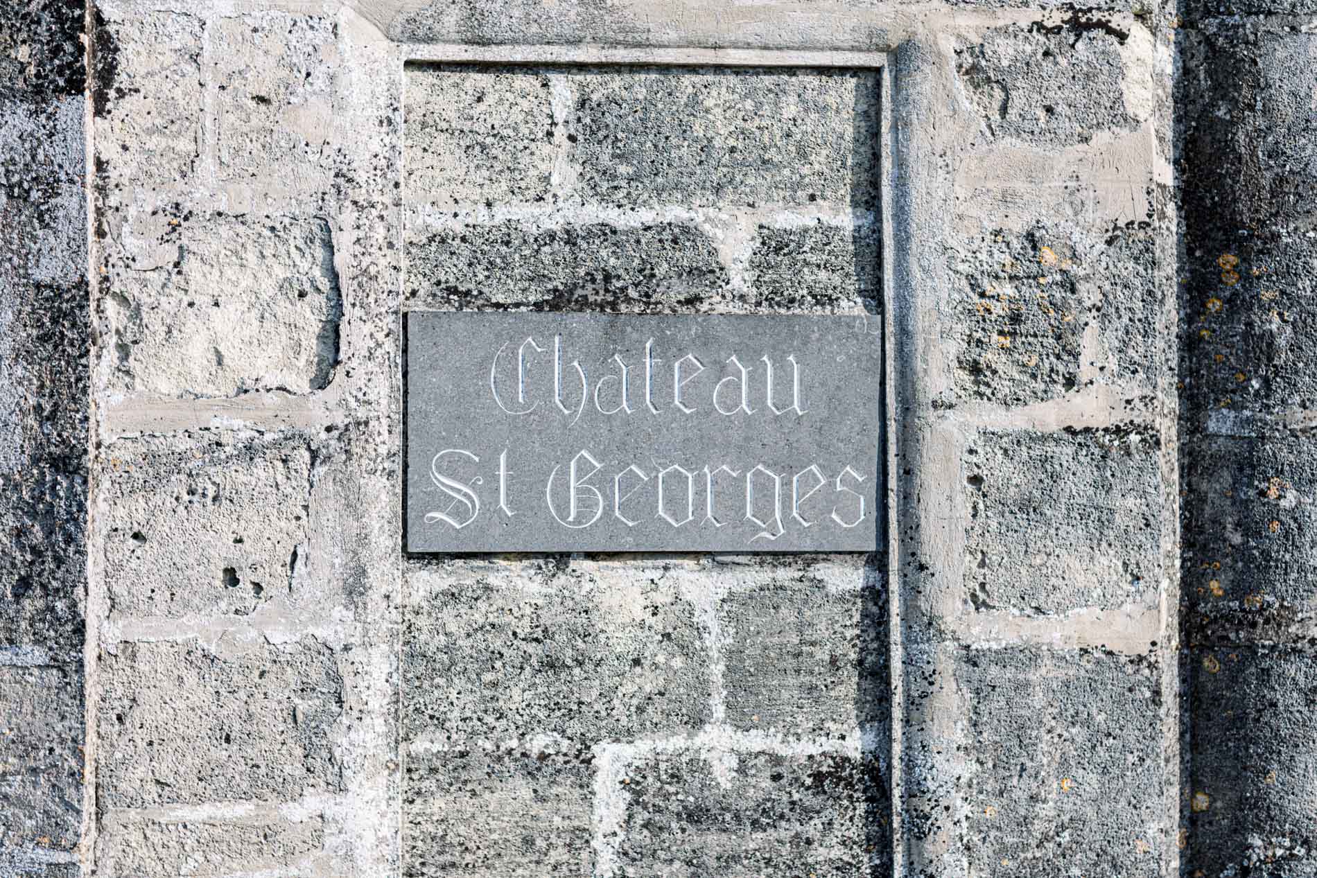 Engraved Château St Georges plaque set in a stone wall