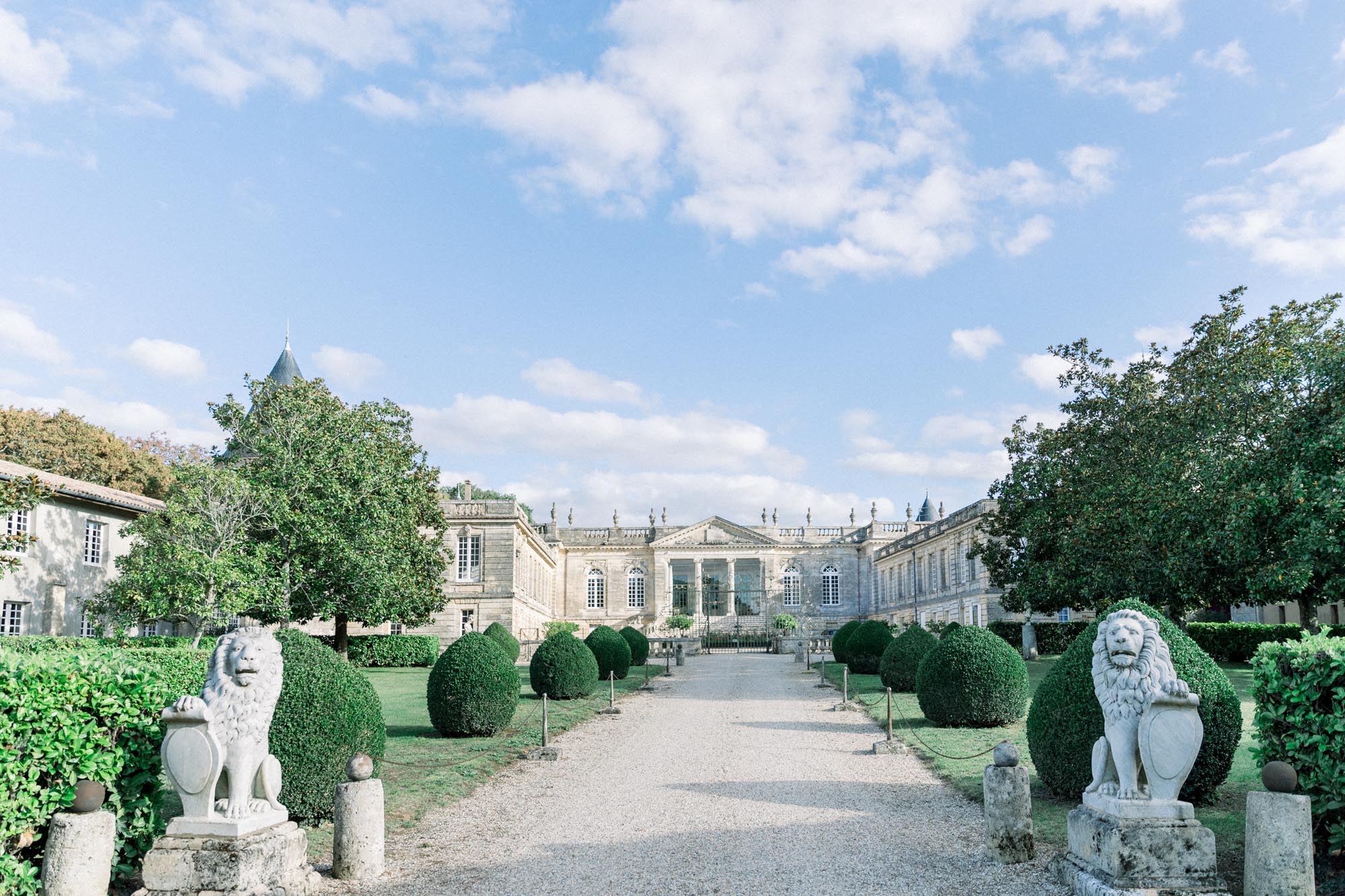 The drive guarded by stone lions leading to Château Saint-Georges
