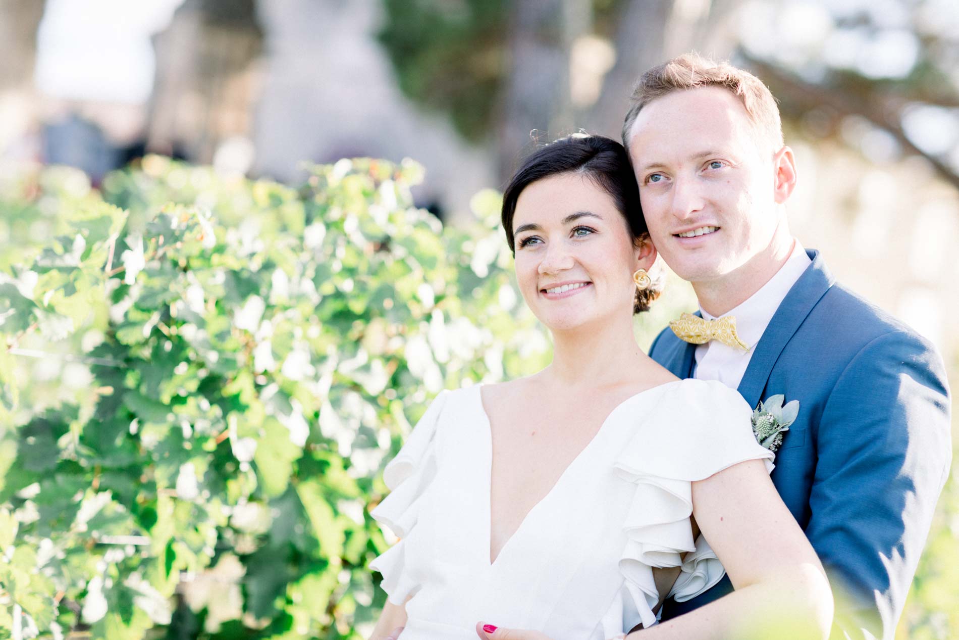 Portrait of the couple cheek to cheek in the sunlit vines