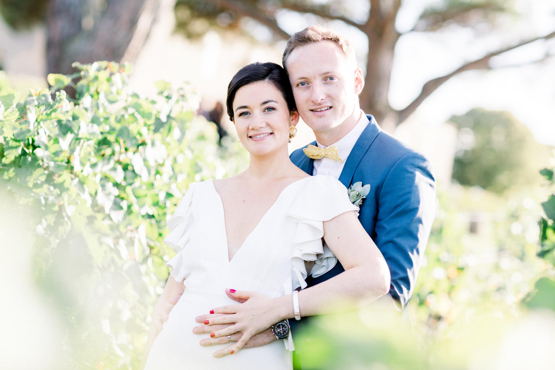 The bride and groom embracing in the vines of Château Saint-Georges near Saint-Émilion