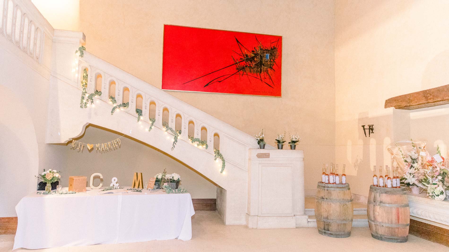Reception room with a staircase, dessert table and wine barrels