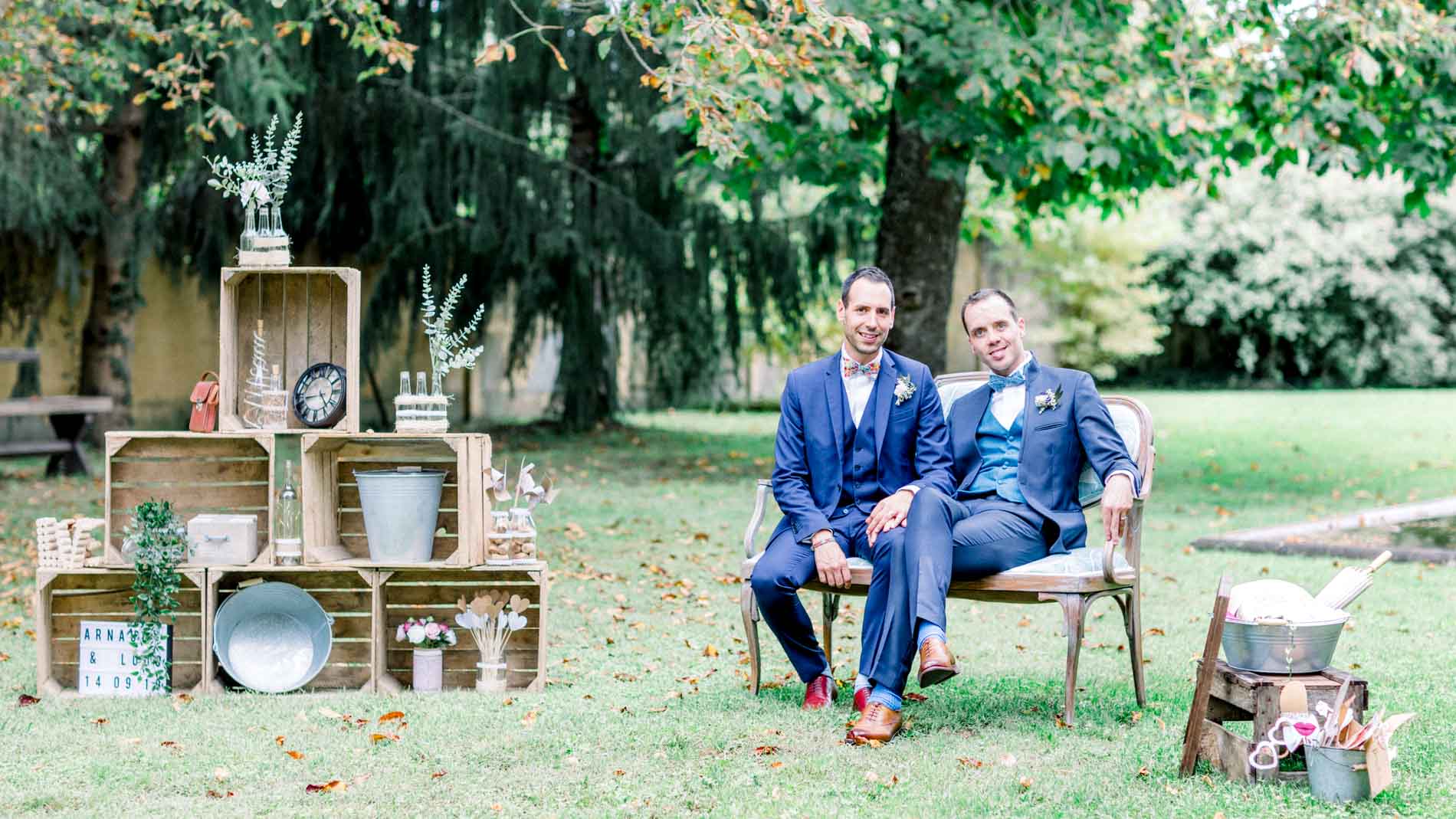 Arnaud and Ludovic on a bench among wooden crates at Domaine de Valmont