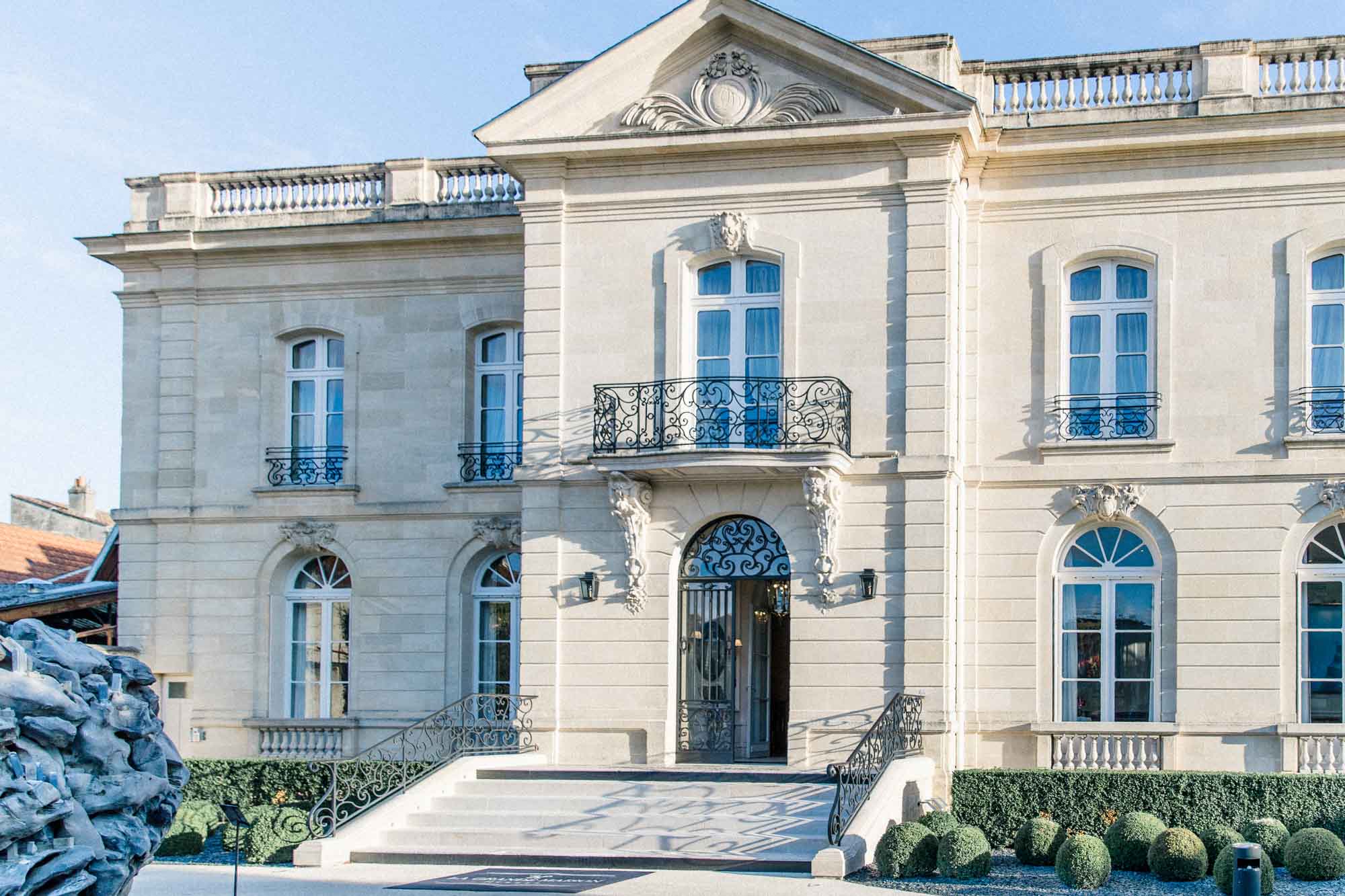 Classical façade of La Grande Maison de Bernard Magrez in Bordeaux under a blue sky