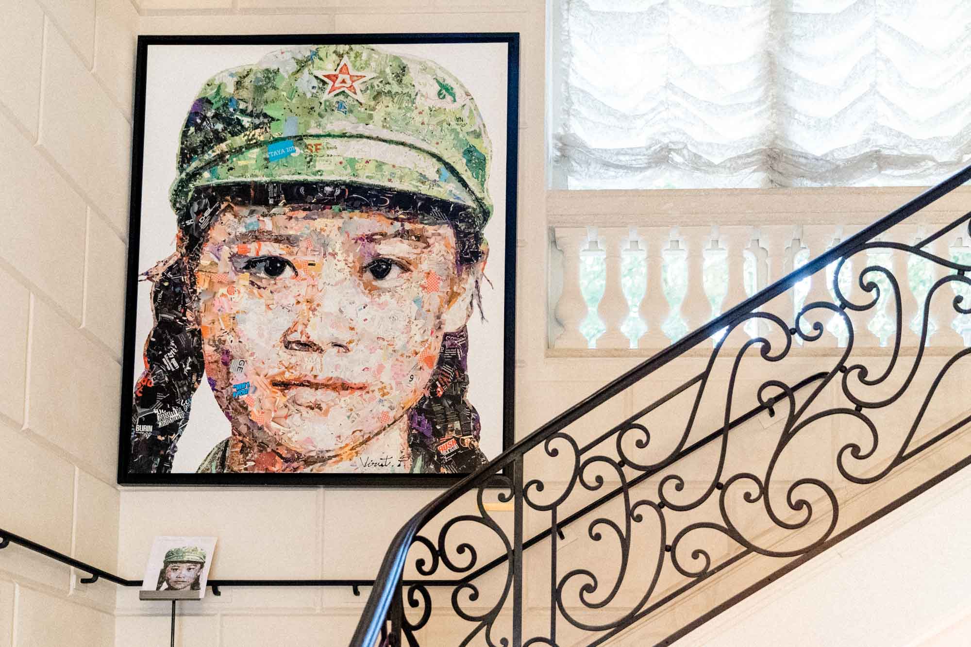 Mosaic portrait and wrought-iron banister on the staircase of La Grande Maison