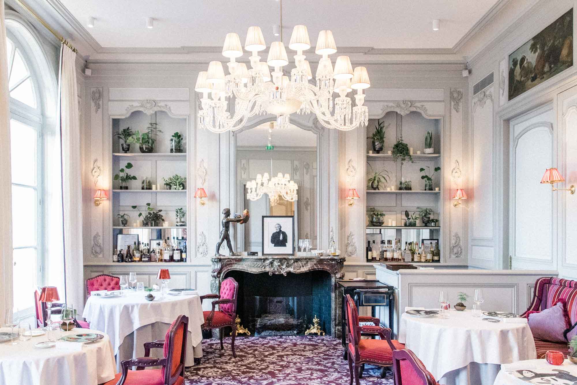 Pierre Gagnaire's dining room at La Grande Maison, chandeliers and laid tables