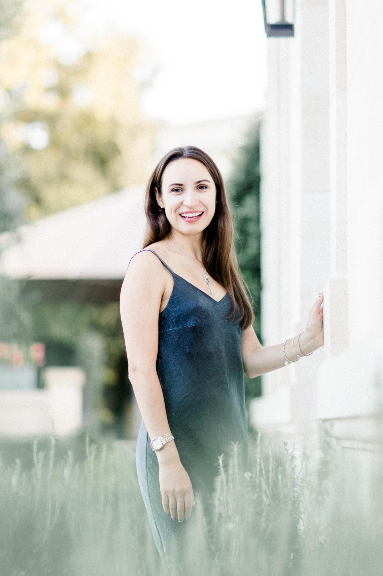 The young woman smiling among the lavender before the stone façade