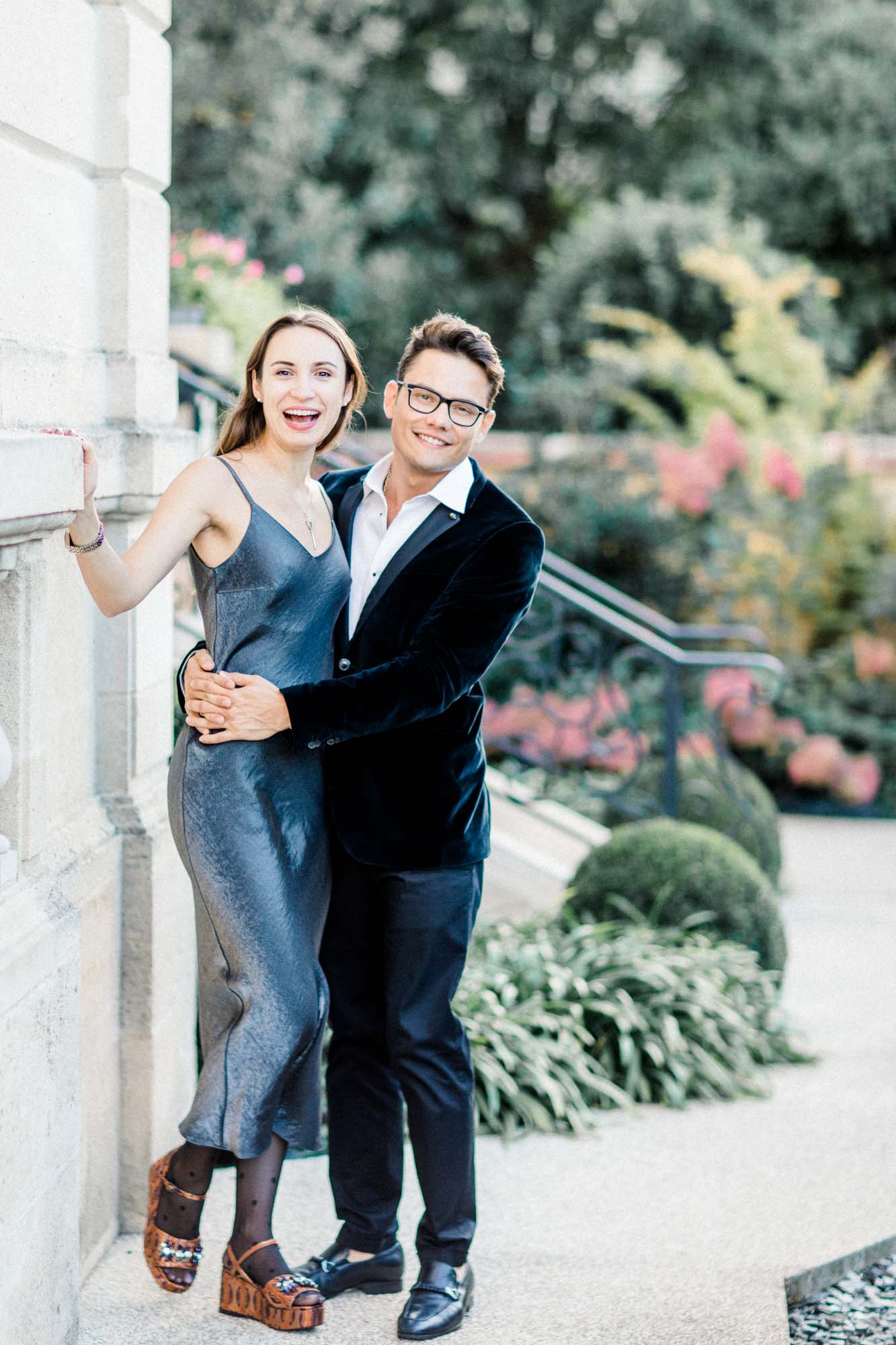 The joyful couple embracing on the front steps of La Grande Maison