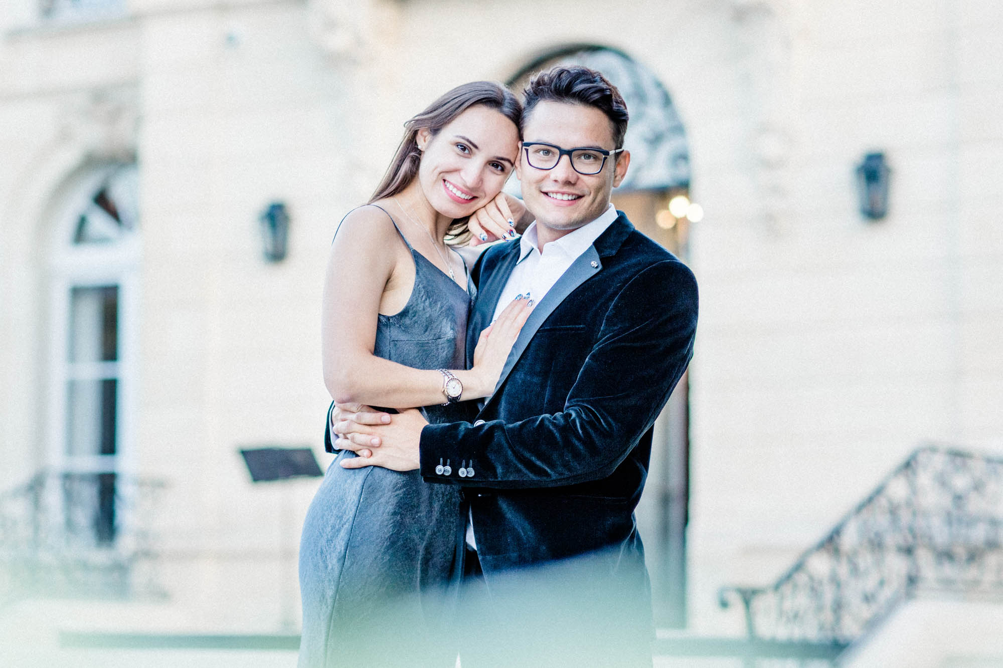 The smiling couple embracing before the façade of La Grande Maison de Bernard Magrez