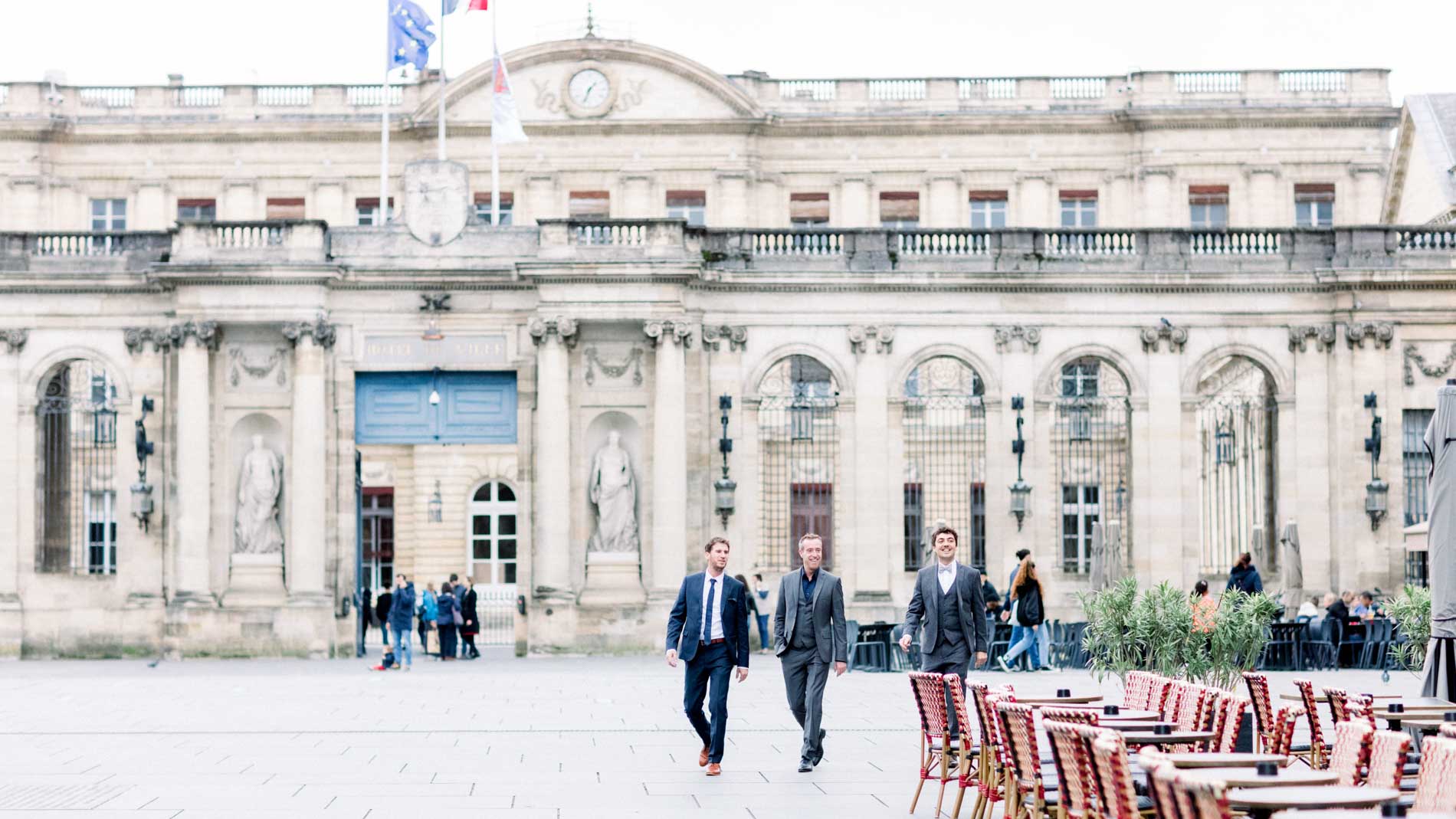 The couple and their family crossing the square in front of Bordeaux town hall