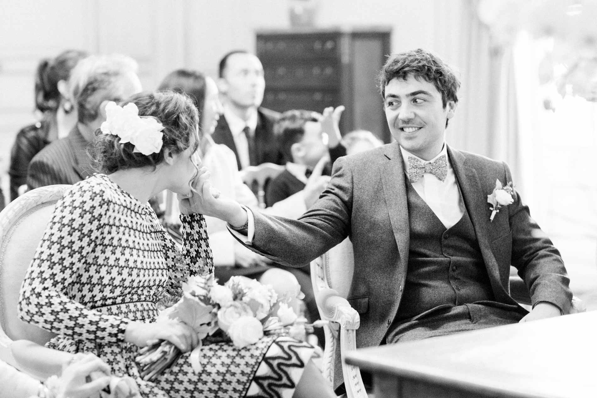 The couple sharing a knowing look during the civil ceremony, in black and white
