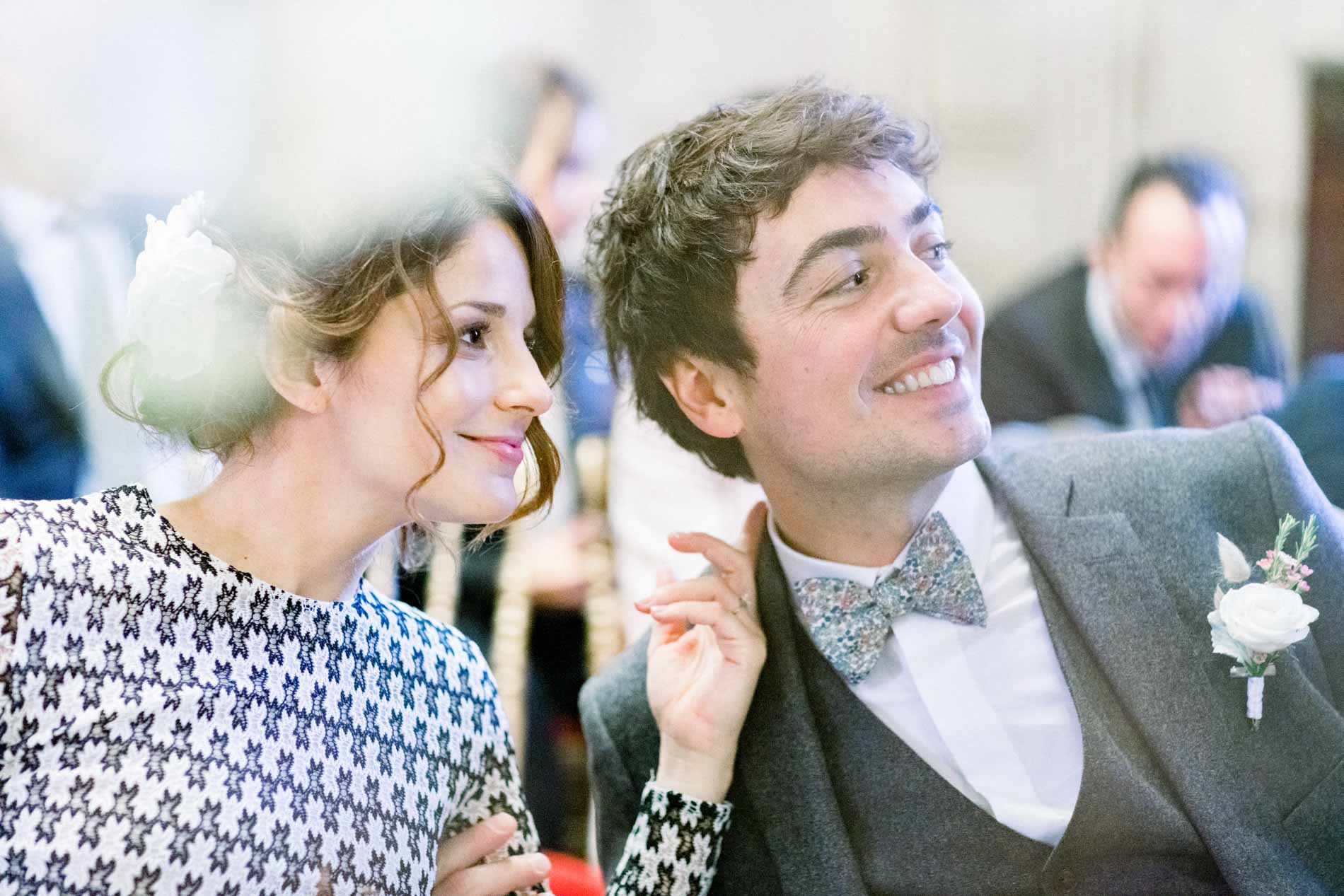 The groom smiling at the bride during the civil ceremony at Bordeaux town hall