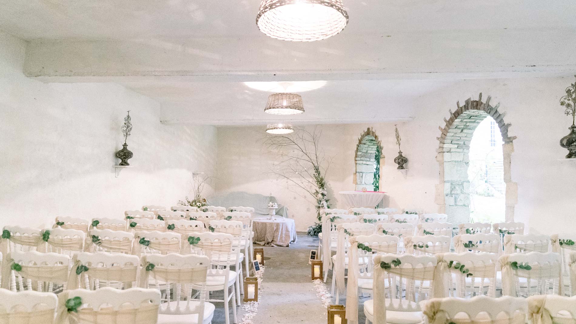 White vaulted room at the Chartreuse des Eyres set up for the celebrant ceremony