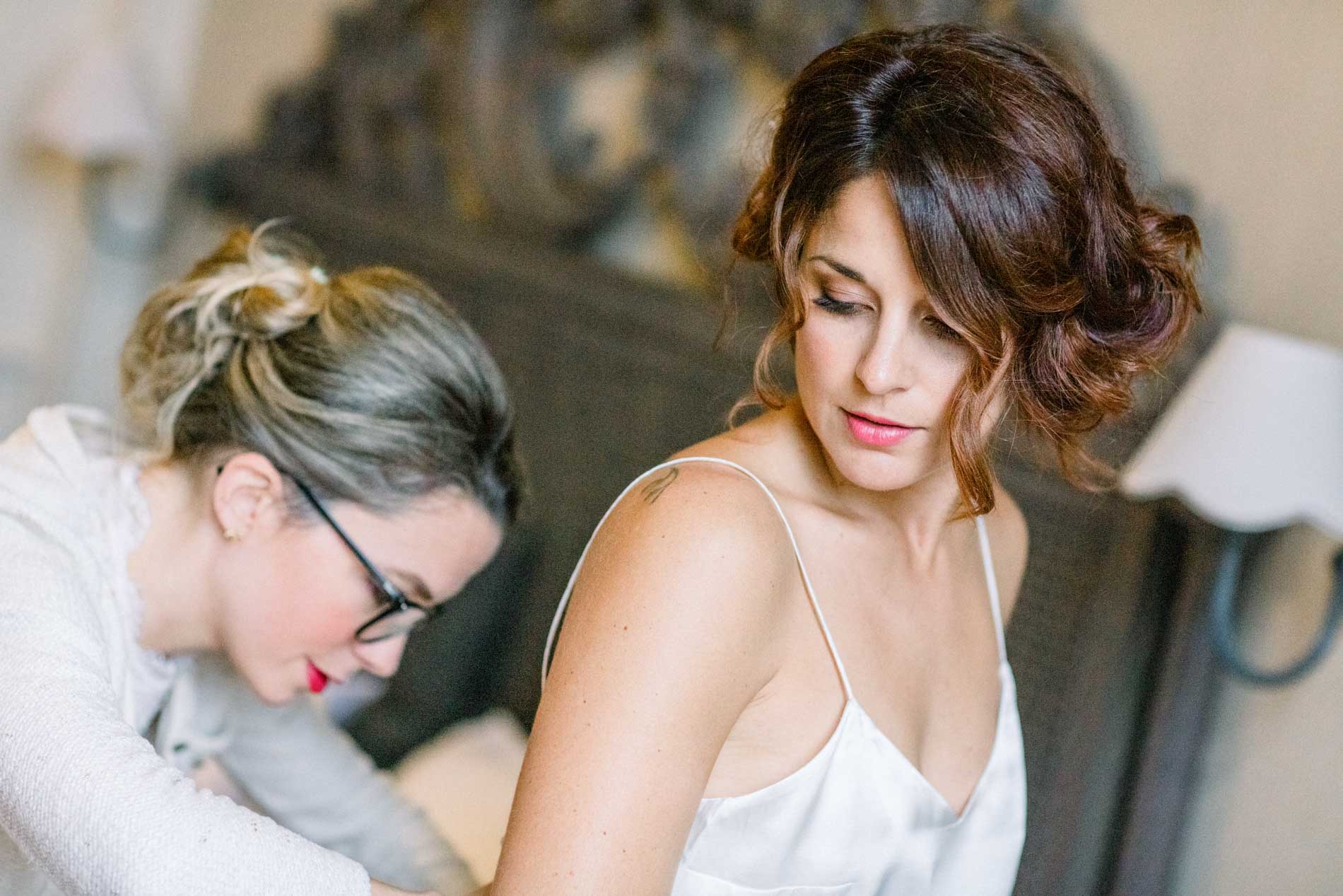 The hairdresser putting the finishing touches to the bride's hair