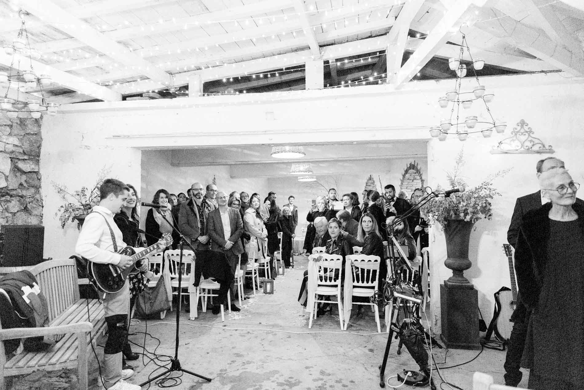 Guests seated during the celebrant-led ceremony, seen in black and white