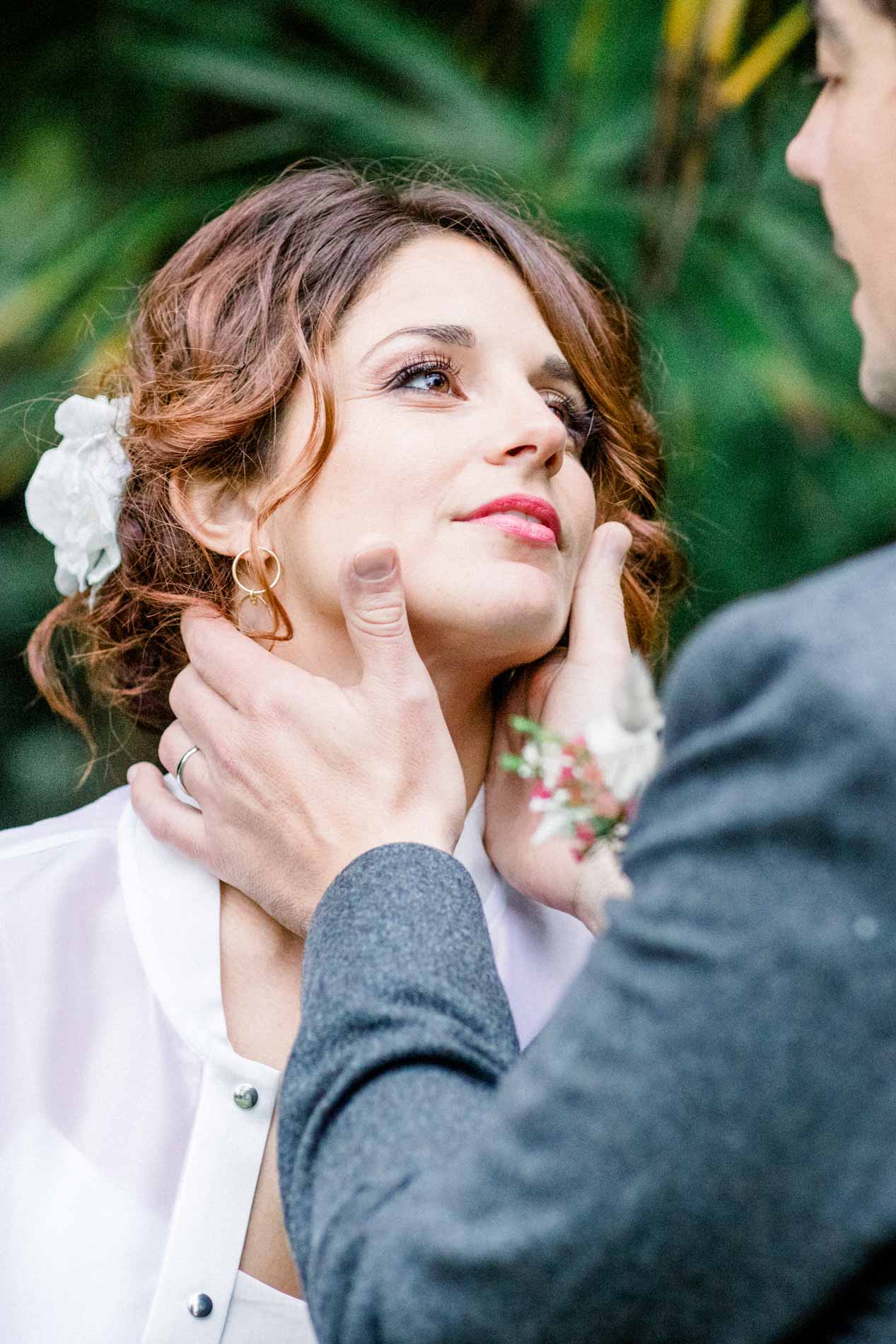 The groom tenderly cradling the bride's face in his hands