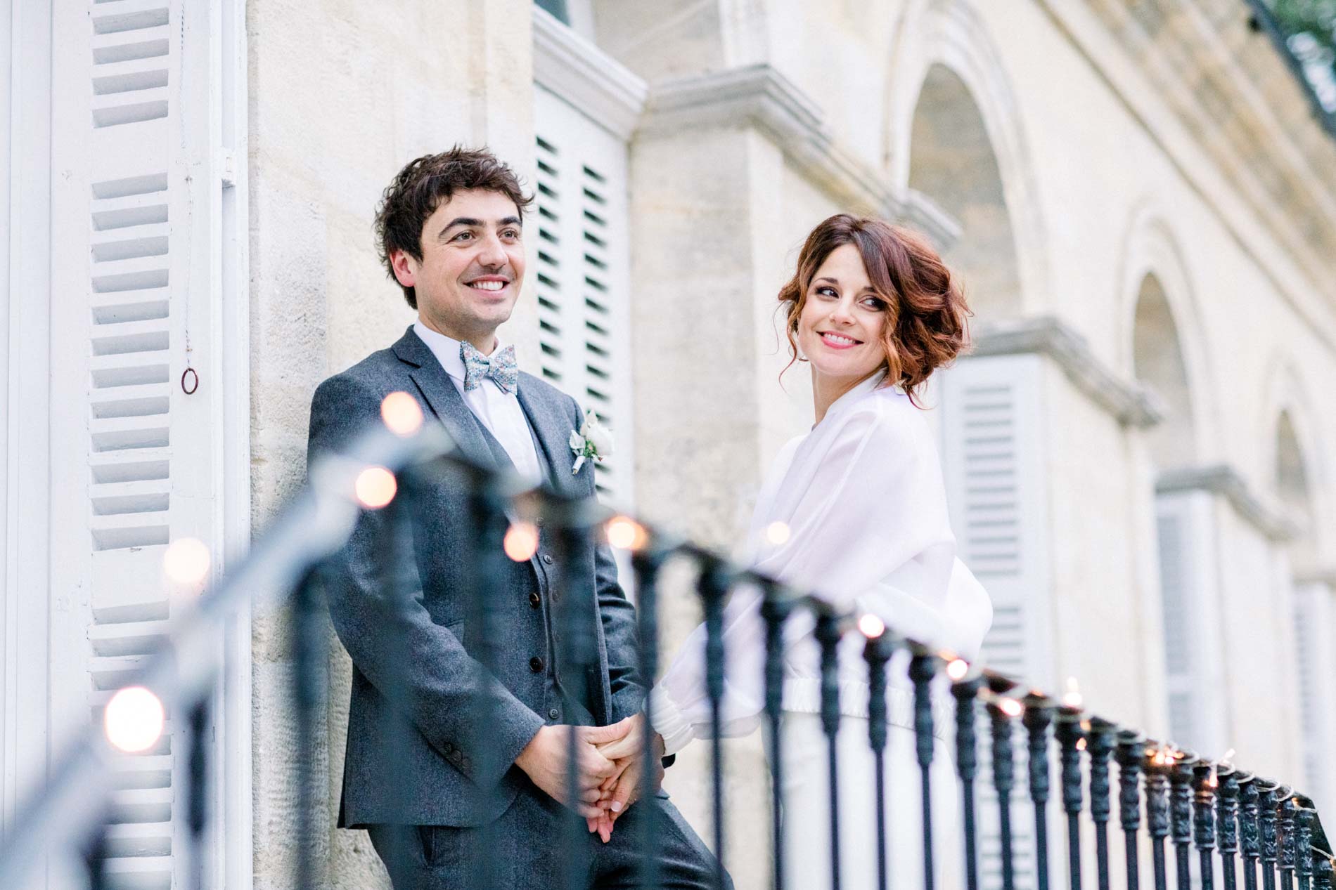 The couple looking at each other across the wrought iron railing