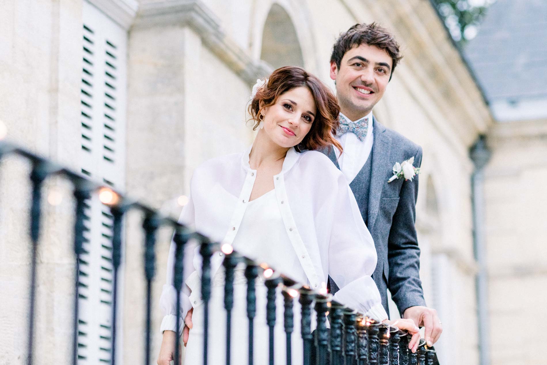 The bride and groom leaning on the outdoor staircase railing at the Chartreuse