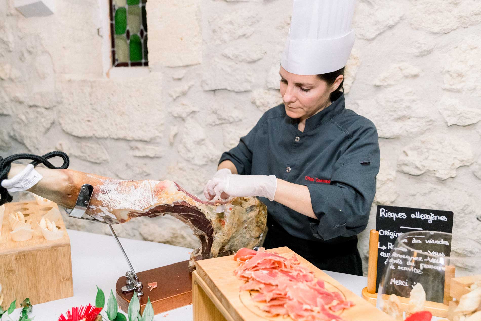 A chef carving ham by hand at the cocktail hour buffet
