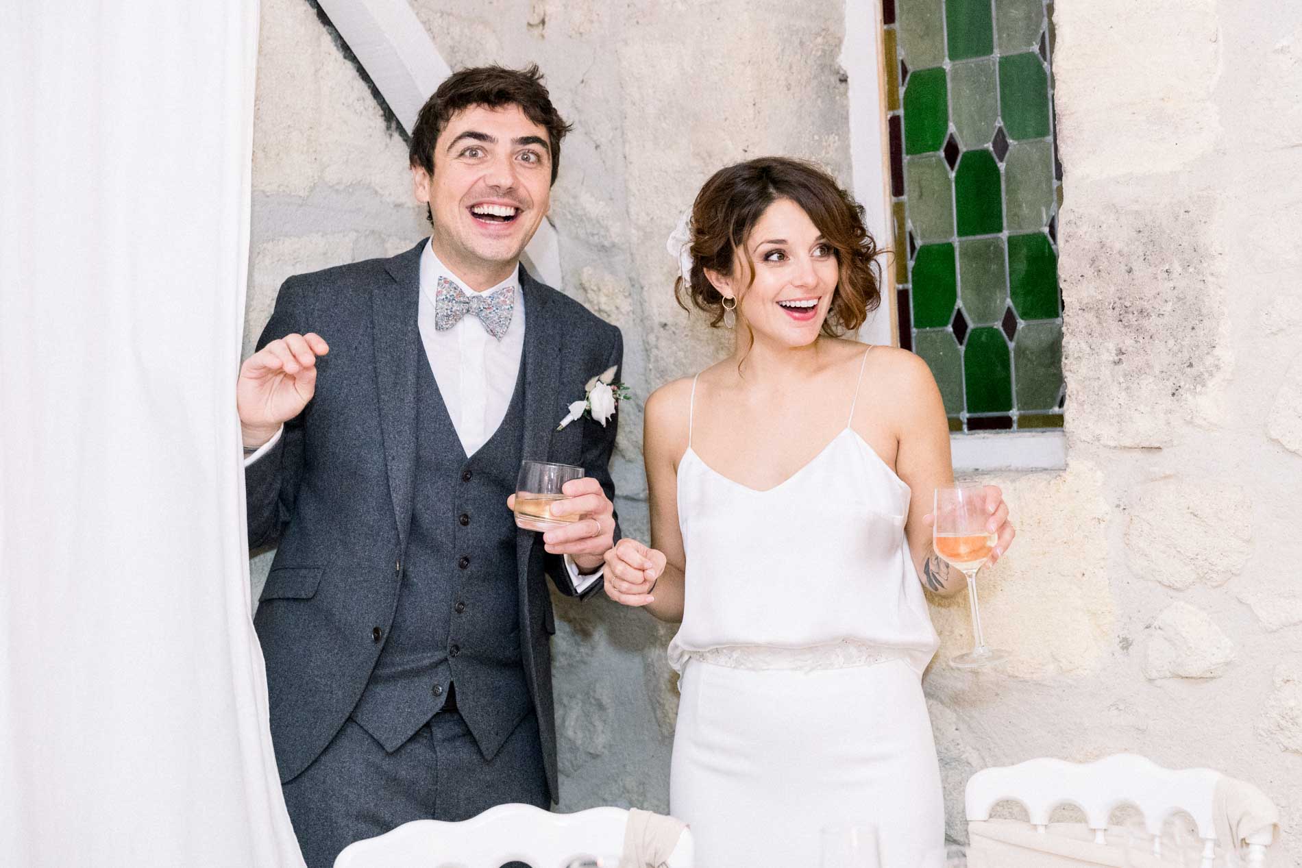 The bride and groom discovering the reception room, drinks in hand