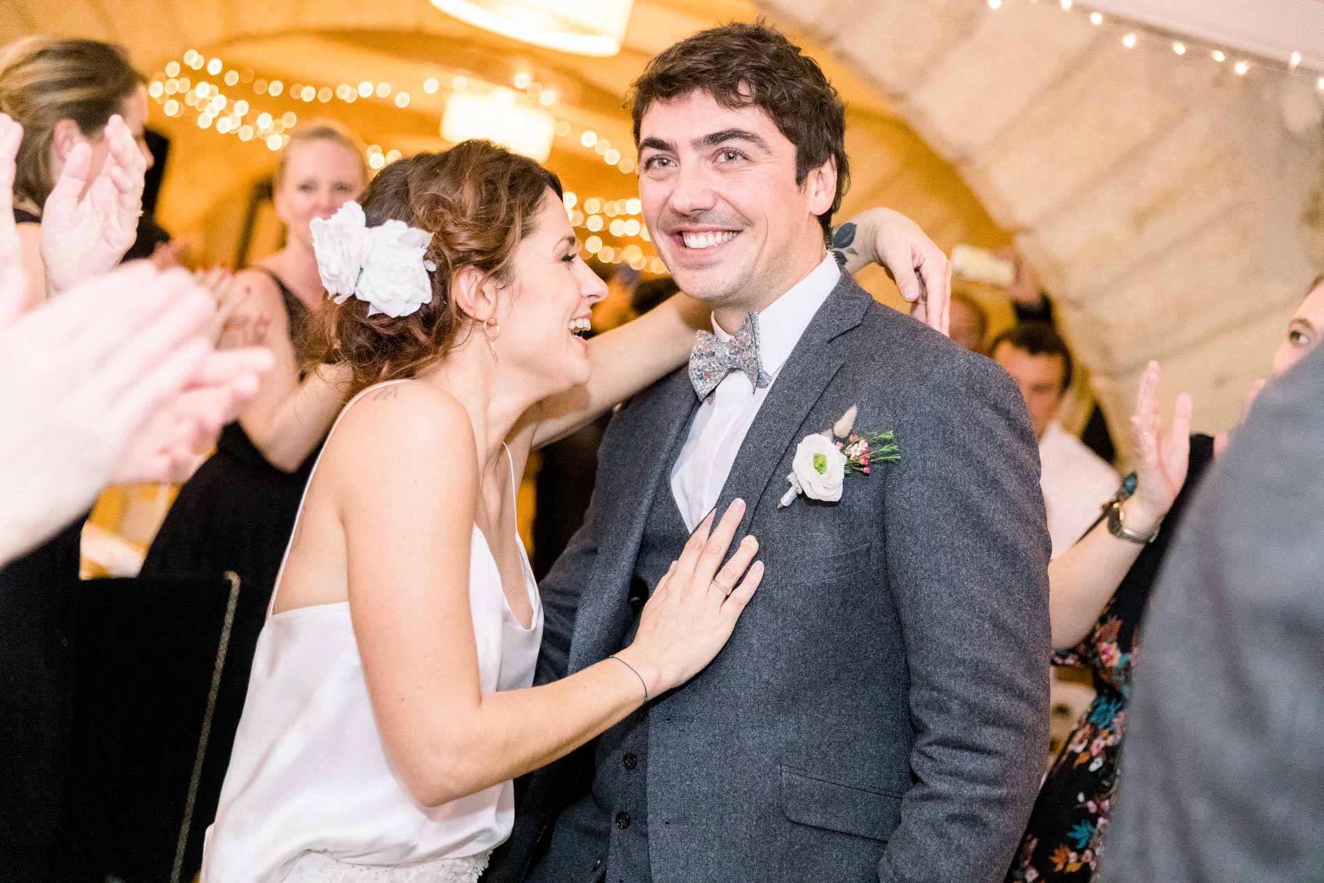 The bride and groom entering the vaulted room to guests' applause