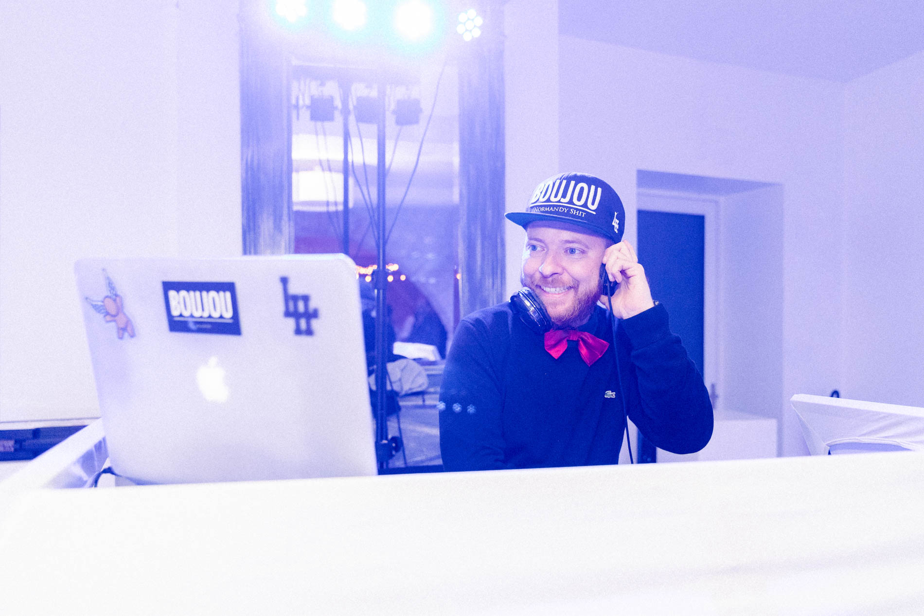 DJ Boujou at the decks under the blue lights of the party