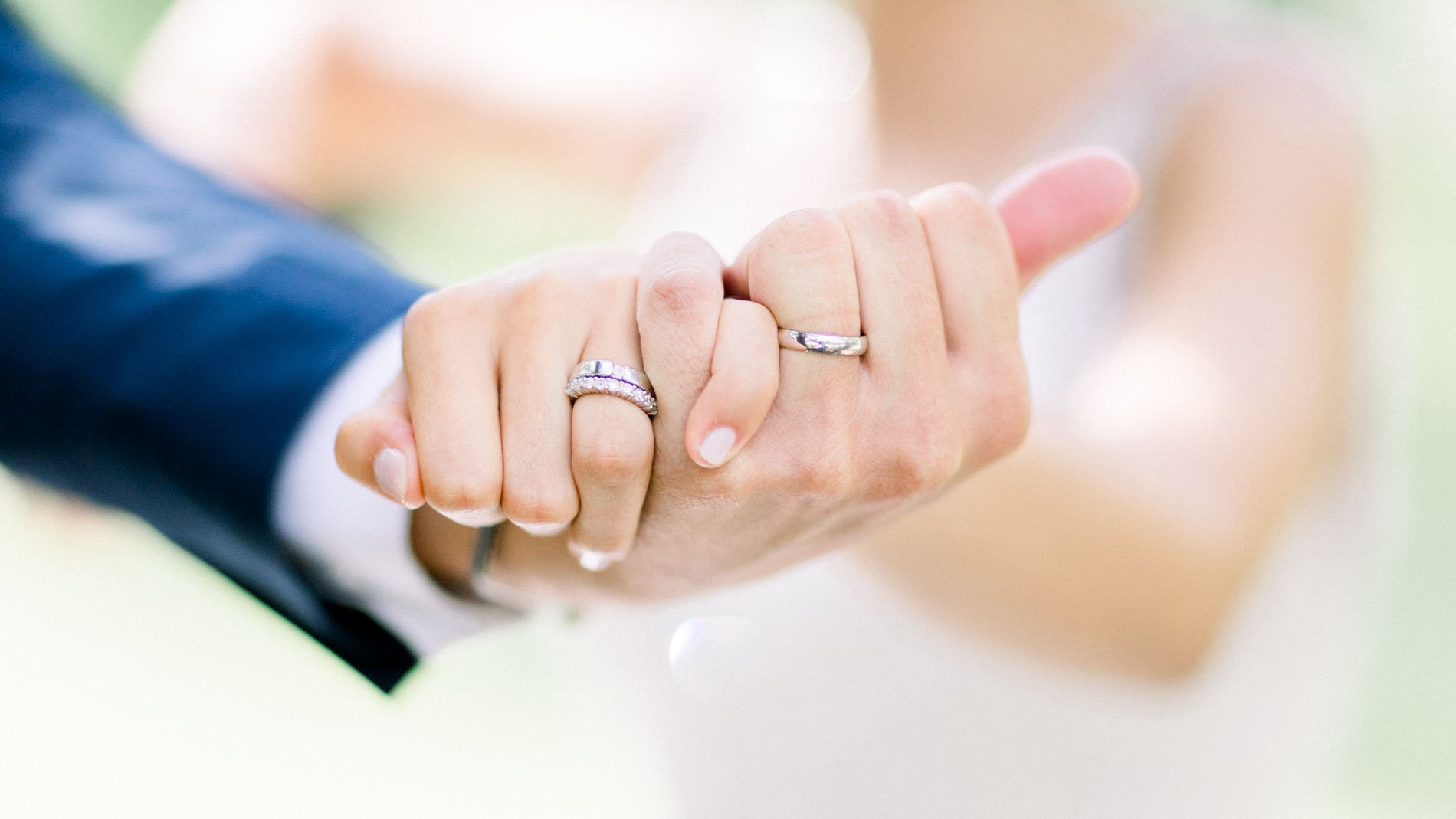 Close-up of the newlyweds' hands and wedding rings at Château de Cujac