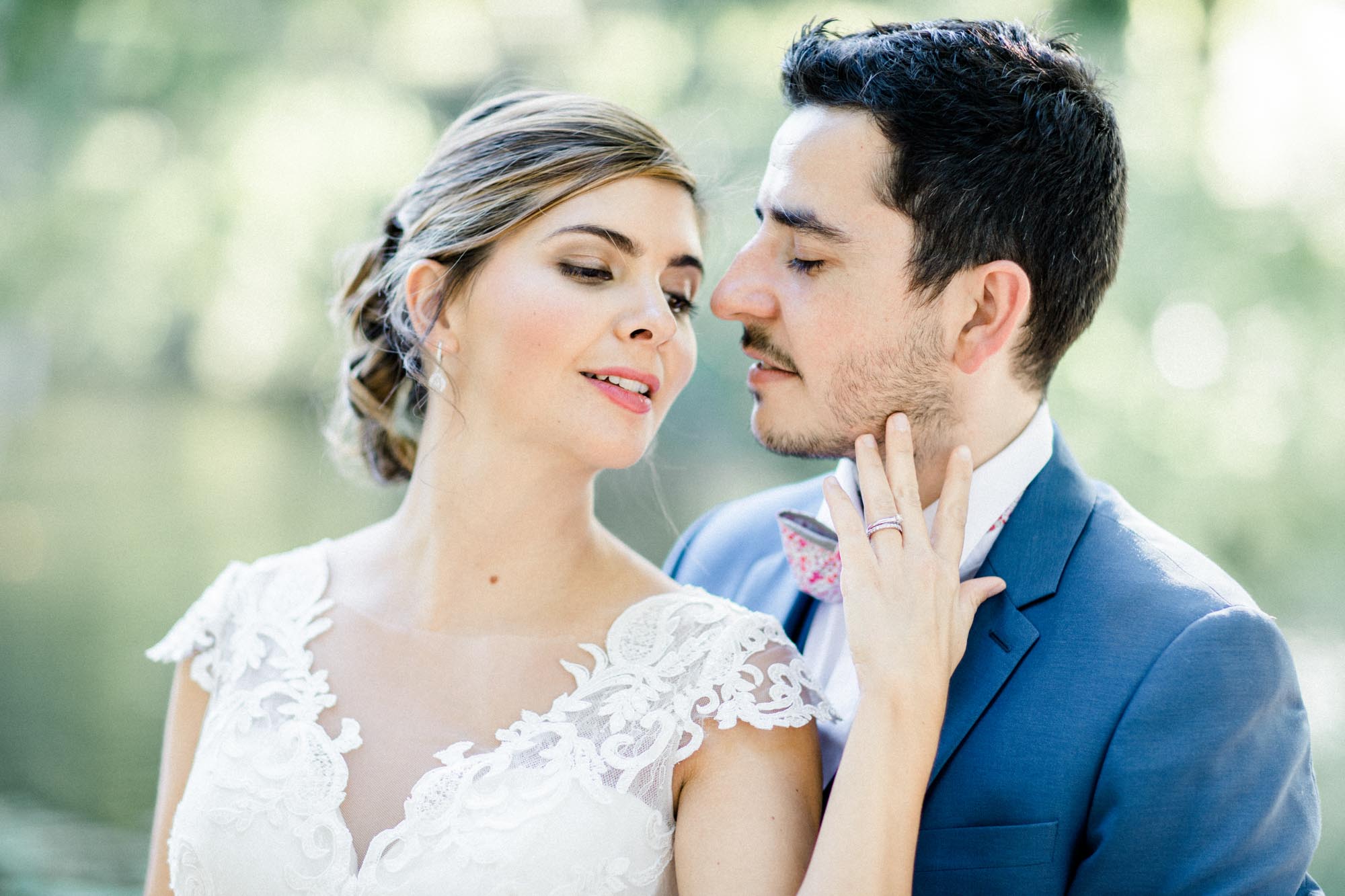 Close-up of the couple, the bride touching the groom's face