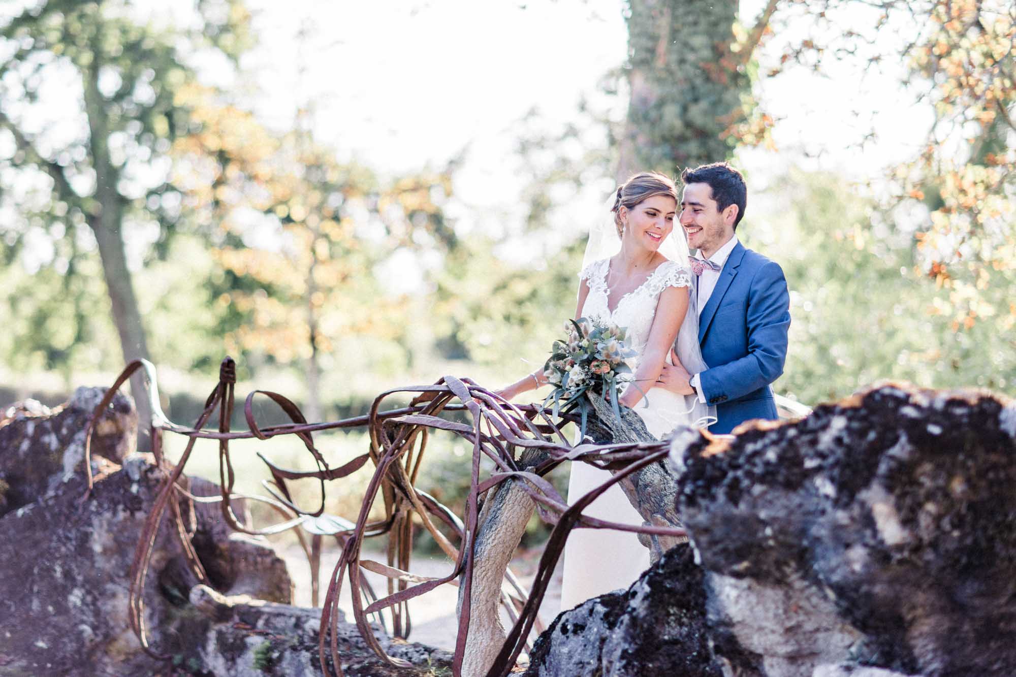 Couple on the rocks of a folly grotto in Parc de Majolan