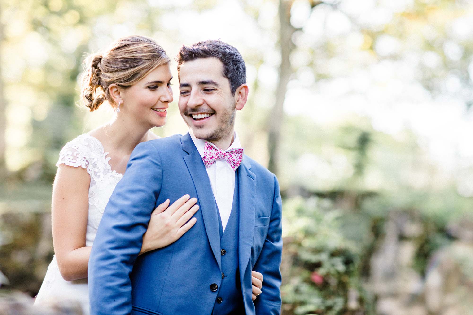 The smiling couple, the groom looking tenderly at the bride