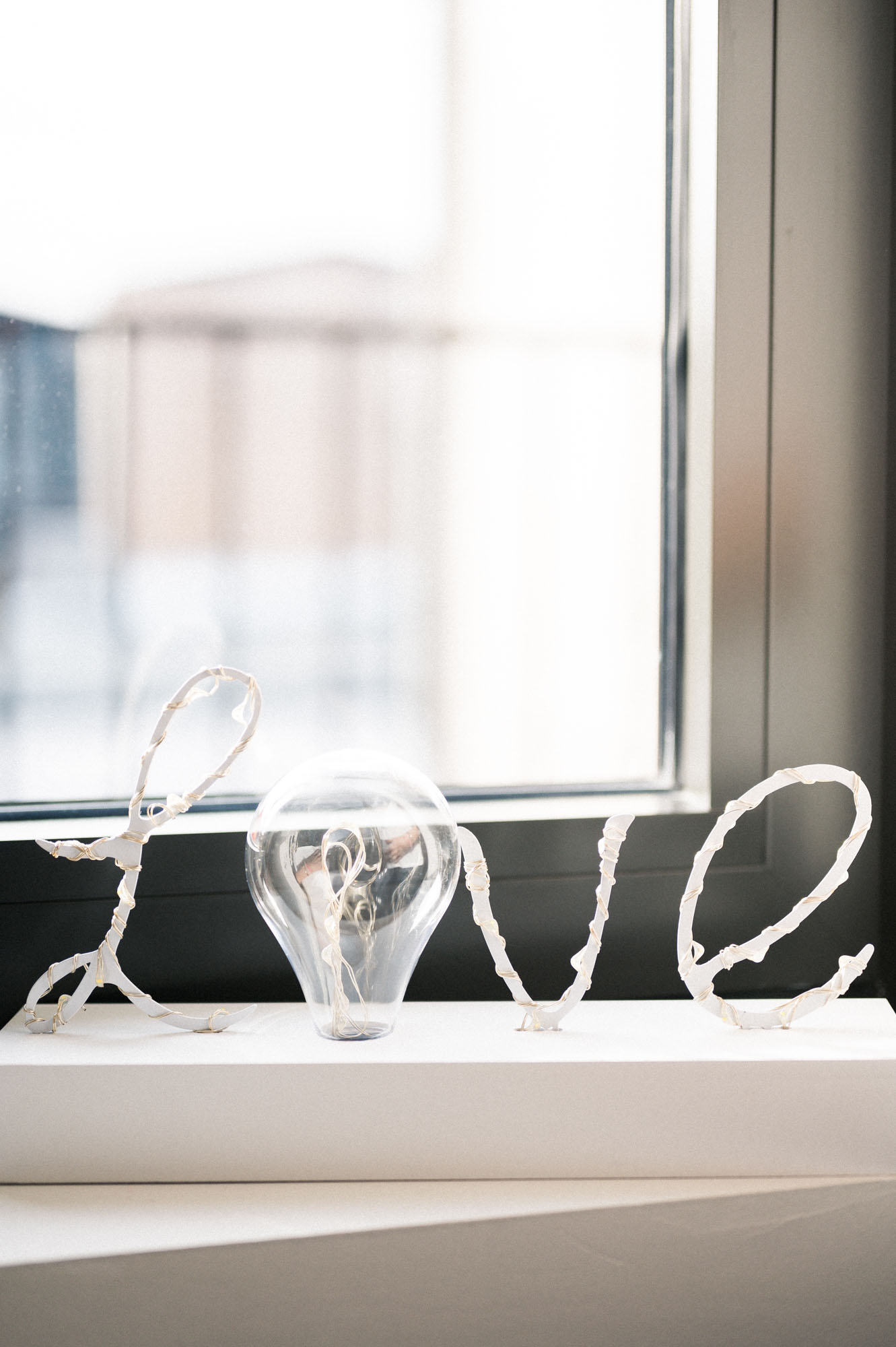 Light-up "Love" lettering and a bulb on the windowsill
