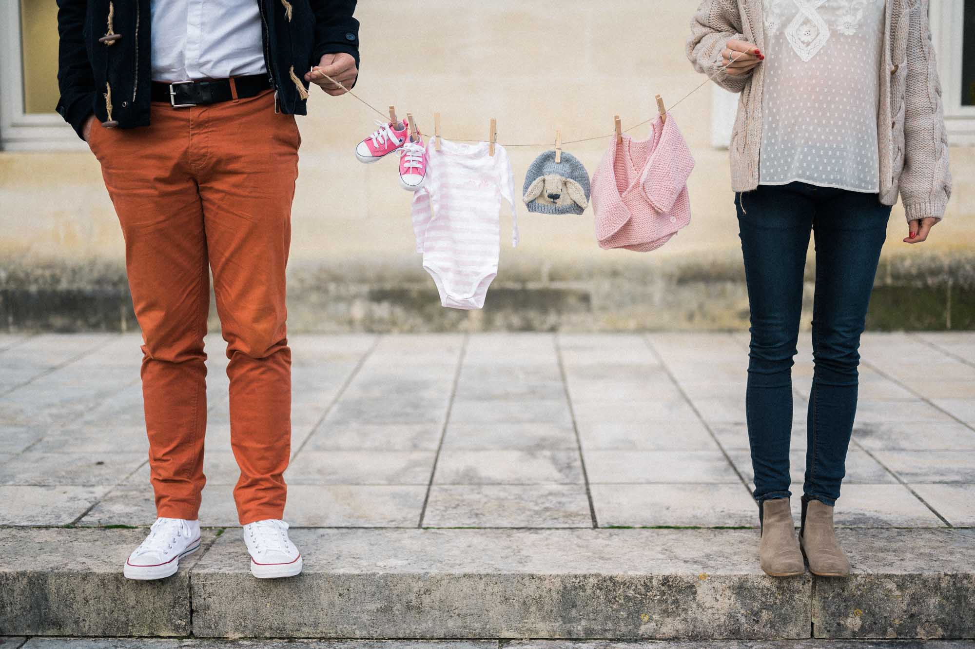 Washing line of baby clothes strung between the parents-to-be