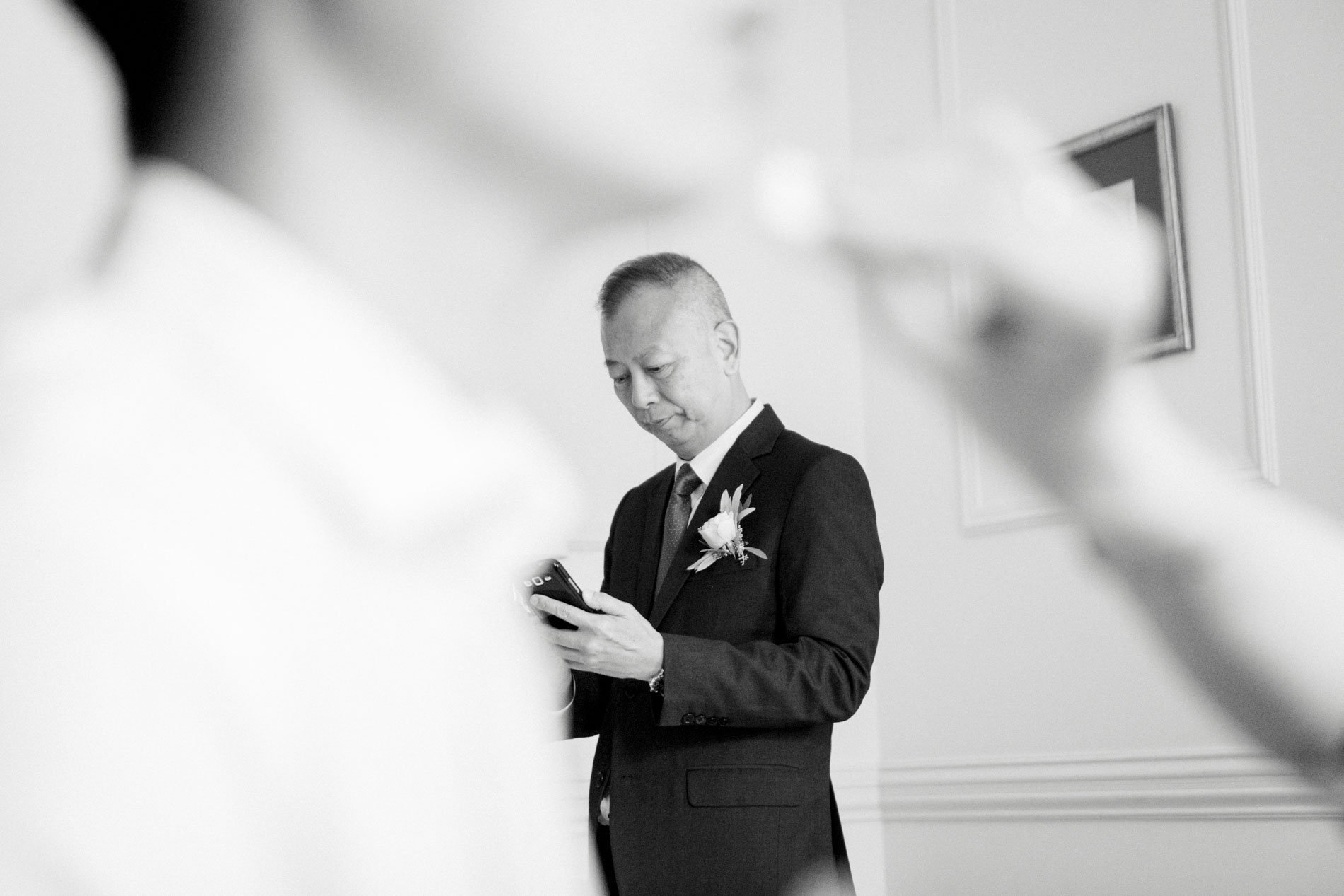 Guest in a suit reading a notebook during the preparations, in black and white