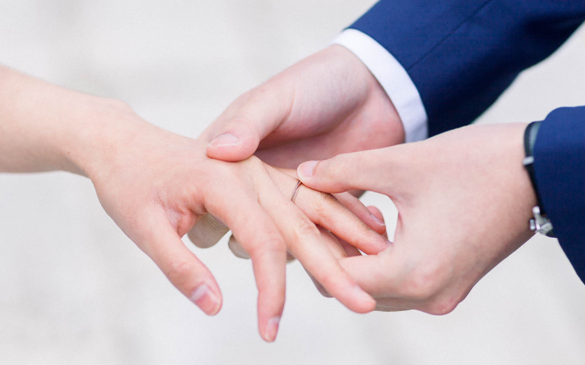 The groom slipping the wedding ring onto the bride's finger