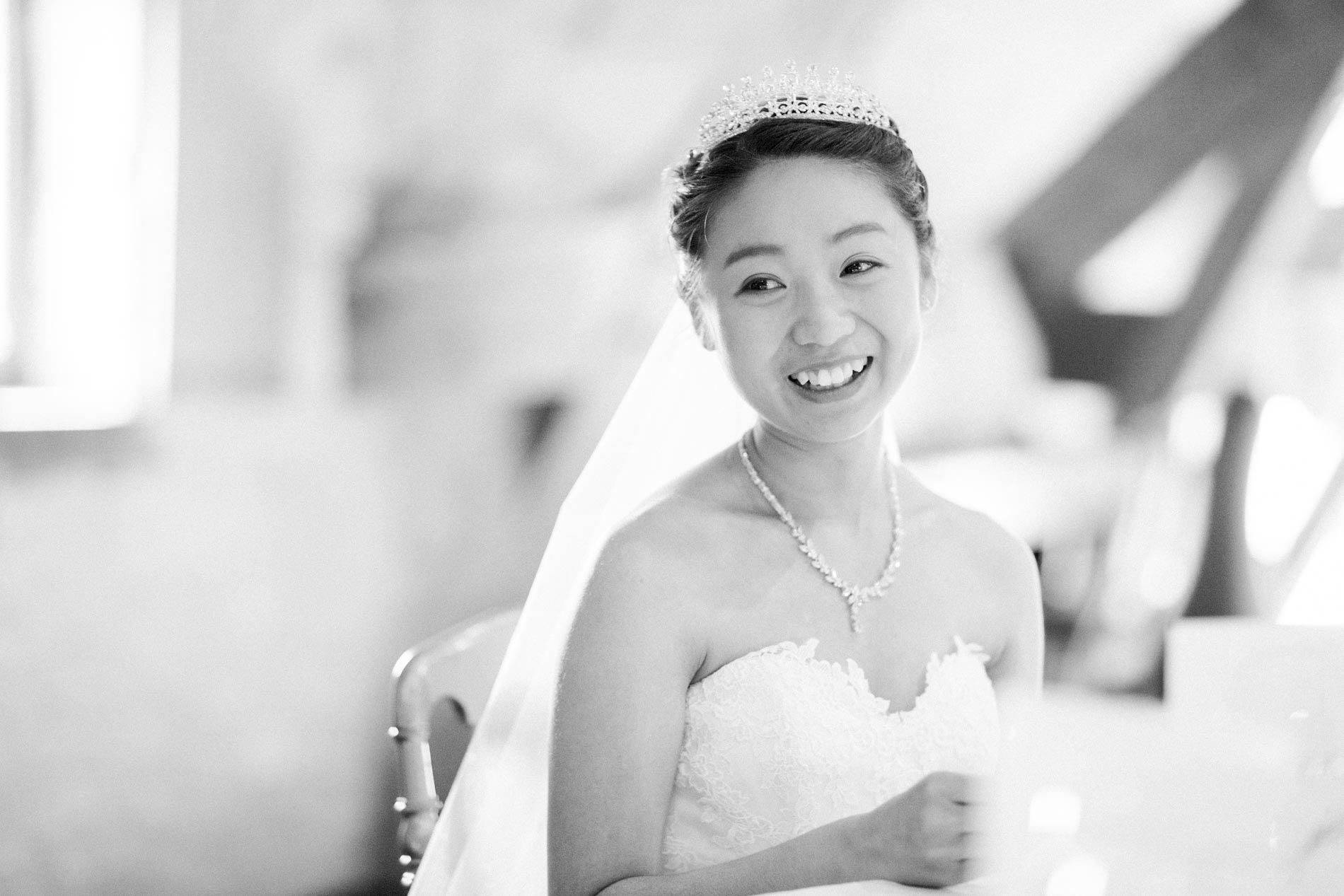 The bride laughing during the wedding reception, in black and white