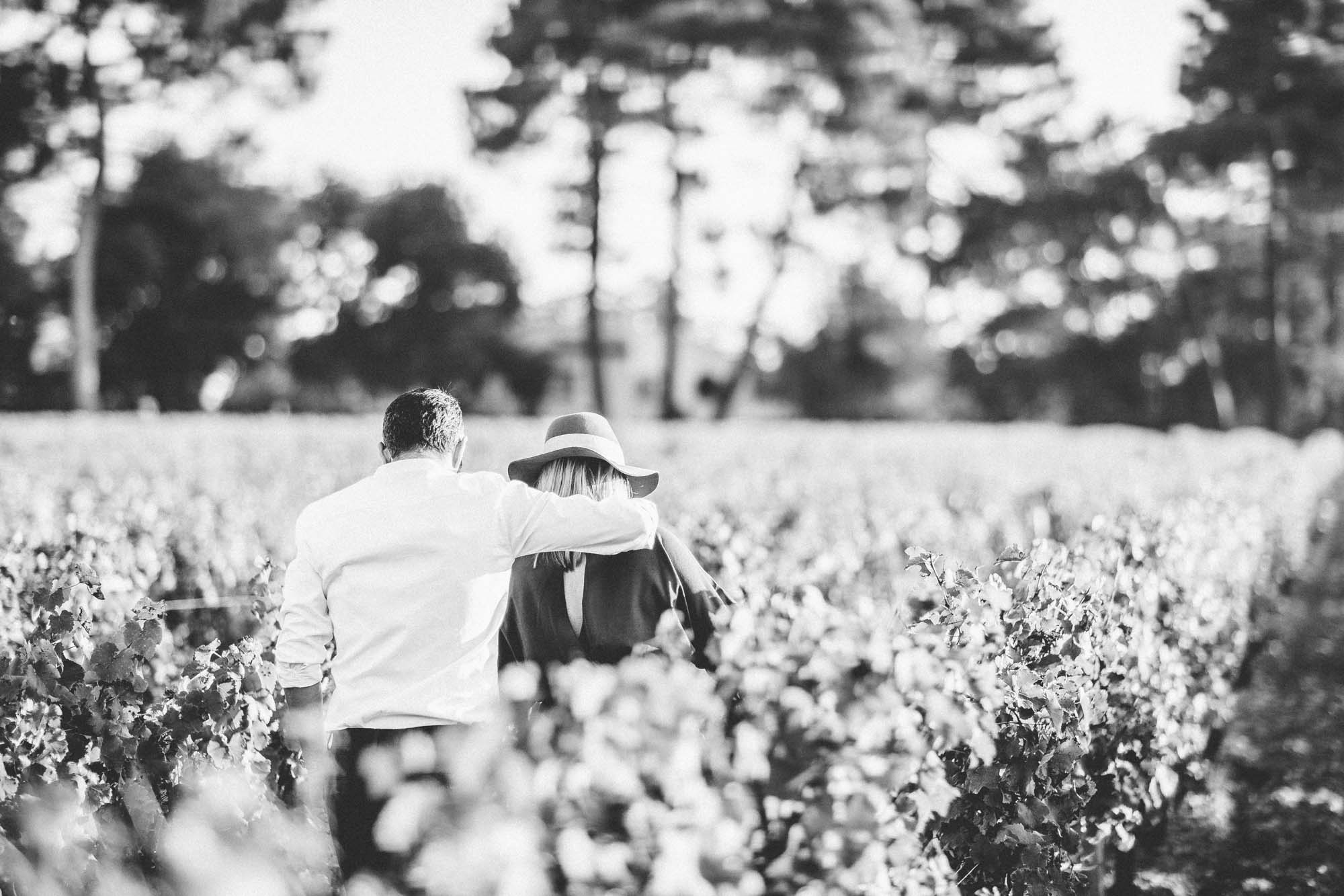 The father-to-be lifting the mother-to-be in the vines, in black and white
