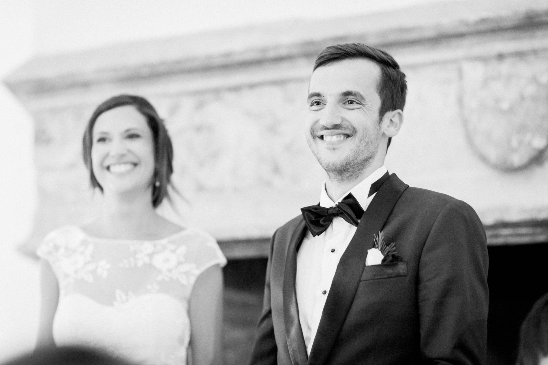 Bride and groom smiling during the dinner speeches, black and white