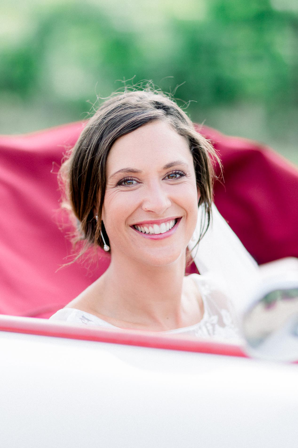 Pearl laughing in the convertible with its red seats