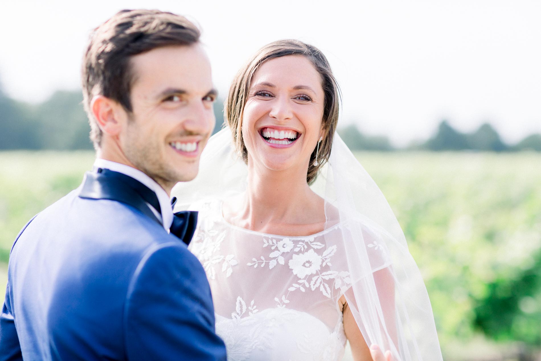 Pearl and Guillaume laughing together in the vineyards of Château Smith Haut Lafitte