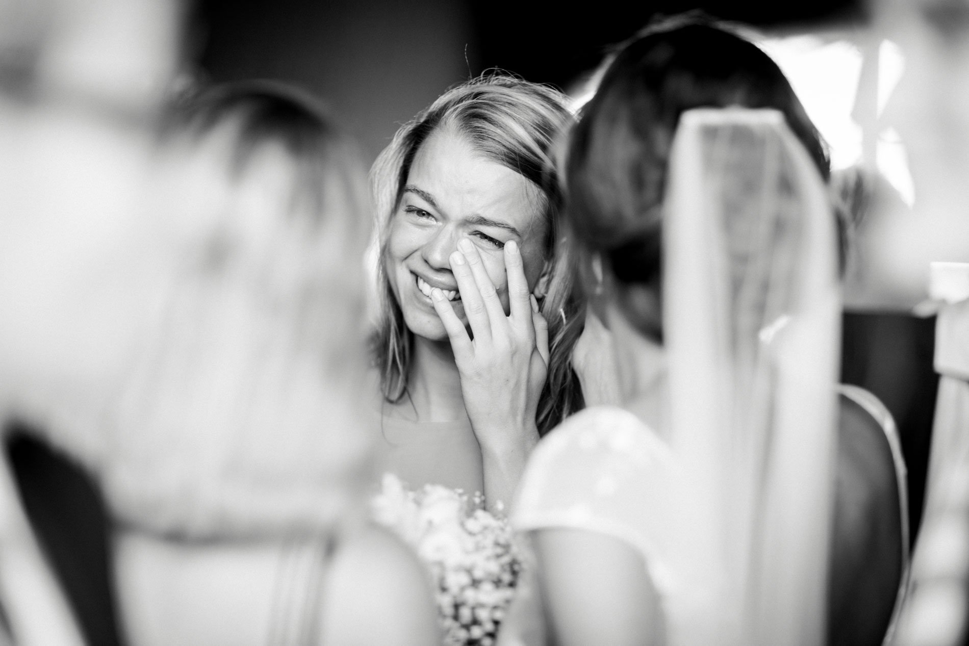 Guest laughing with tears in her eyes during the drinks reception