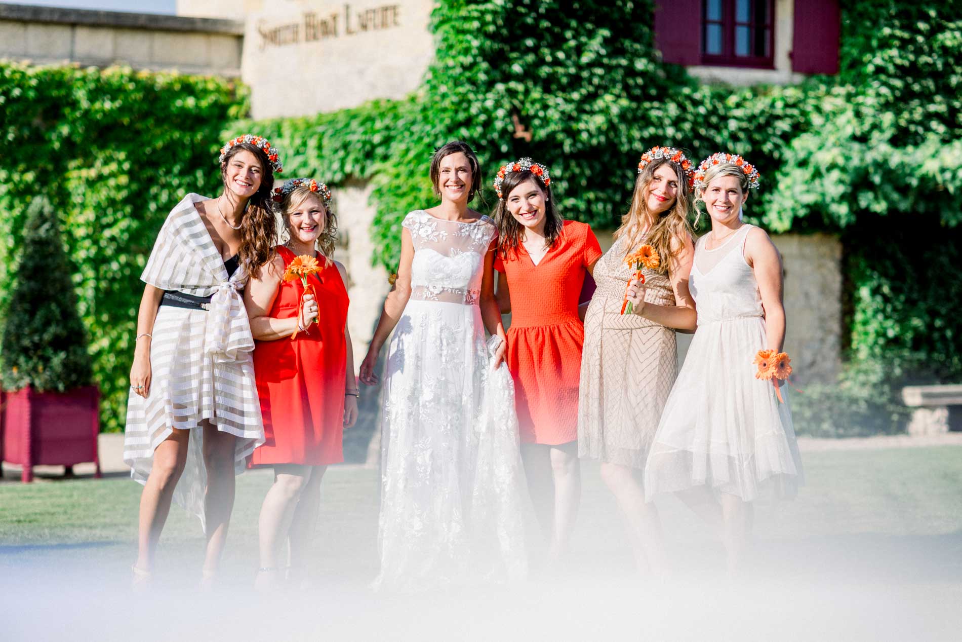 Bride and her friends posing before the château's ivy-covered wall