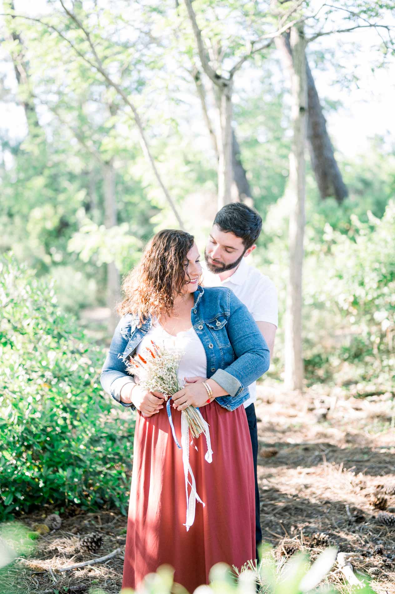 Couple embracing in the pine forest during a photo session