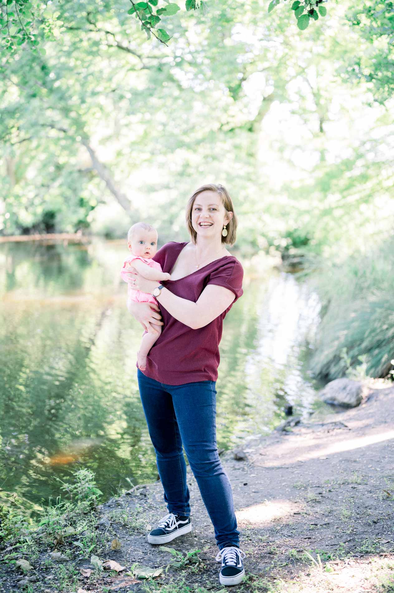 Mum holding her baby by the pond in Parc de Majolan