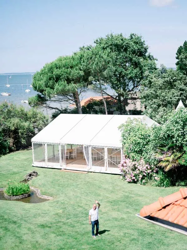 Reception marquee set up on the lawn of Villa La Tosca overlooking the bay