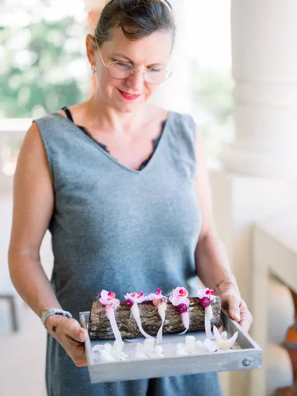 A guest presents the tray of floral boutonnieres during the preparations