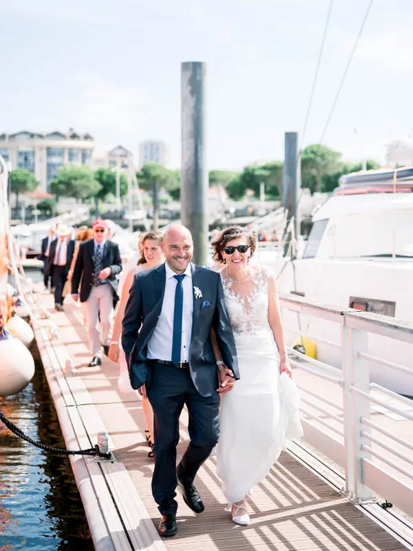Céline and Erwan walk along the pontoon at Arcachon harbour before their boat trip