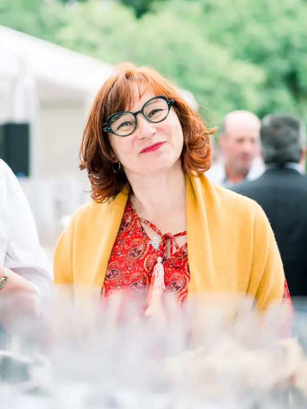 Smiling guest in red glasses during the wedding cocktail hour