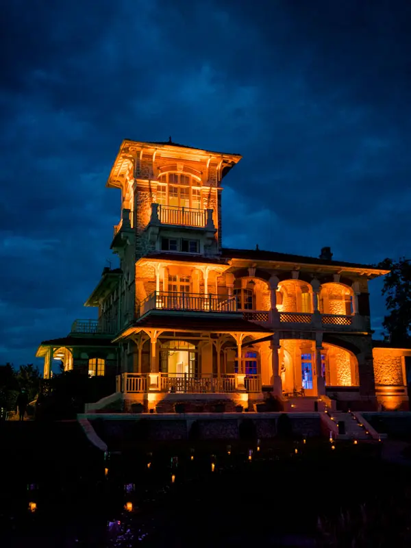 Villa La Tosca lit up at night against a deep blue sky
