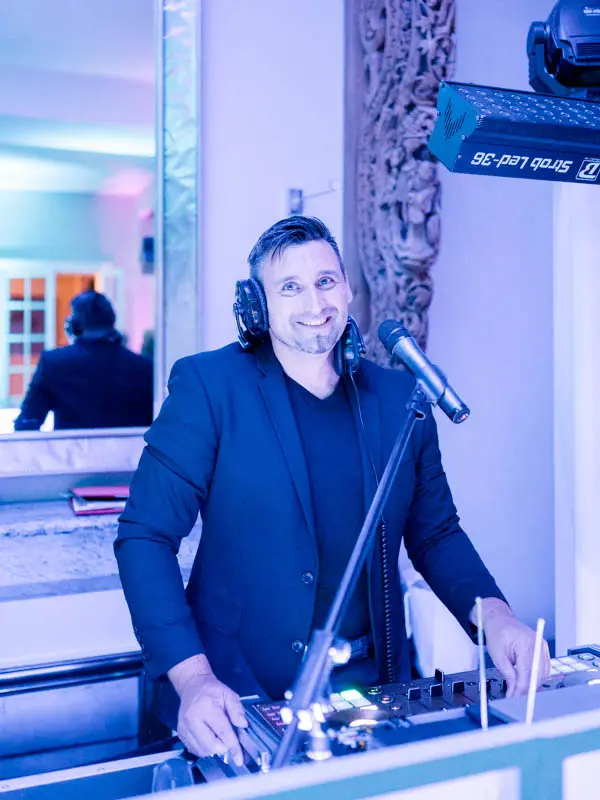 DJ Rudy Alegria at the decks during the wedding party at Villa La Tosca