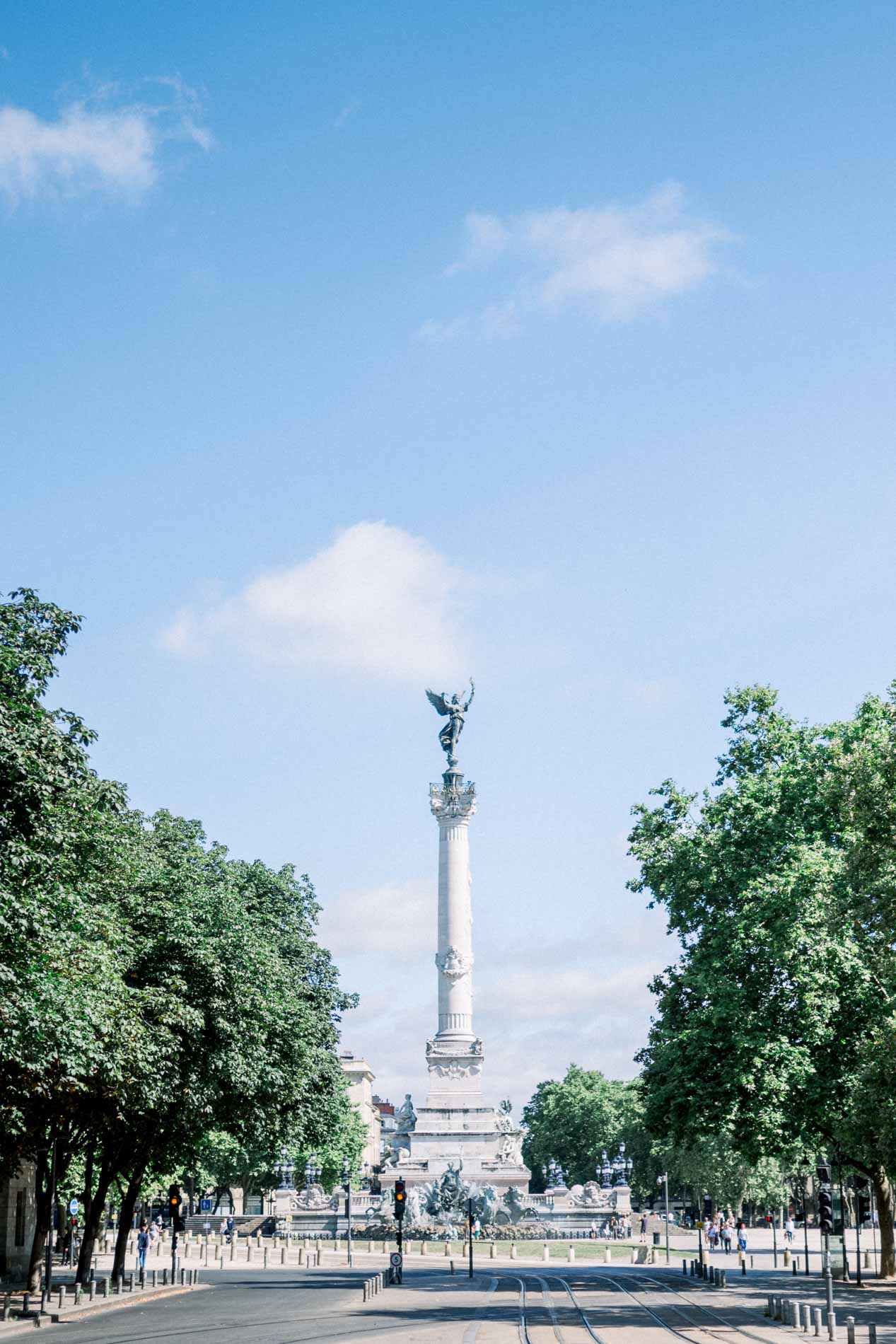 Column of the Girondins monument at the end of a tree-lined avenue in Bordeaux