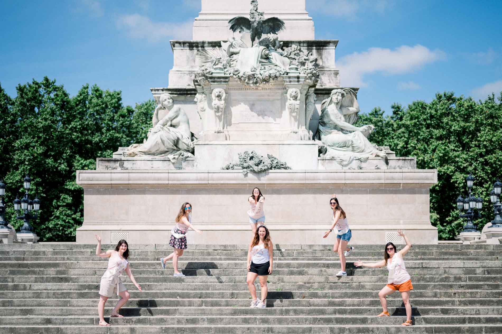 Friends scattered across the white steps of the Girondins monument in Bordeaux
